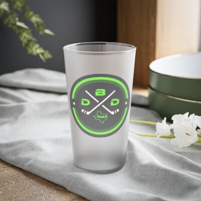 Frosted pint glass with Defending Big D Logo on It