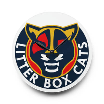 A Wall Clock With Litter Box Cats Logo on the Face